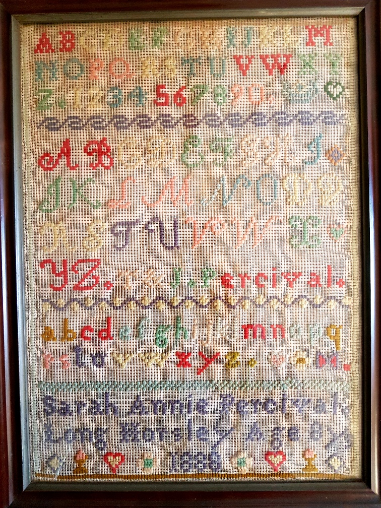 An oak framed and glazed sampler dated 1888 by Sarah Annie Percival of Long Horsley.