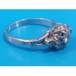 18ct White Gold and Diamond Ring set with 11 small diamonds and 1 larger. Total weight is 3.64g,