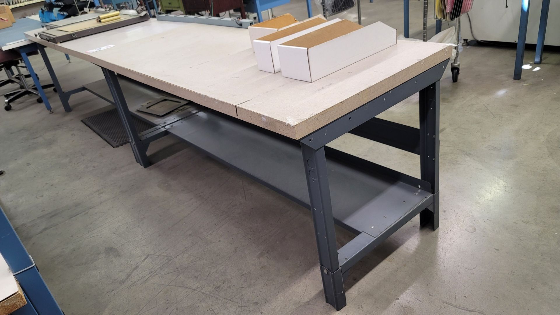 LOT - (2) STEEL TABLES W/ PARTICLE BOARD TOP, EACH TABLE IS 6' X 30" X 31" HT, NO CONTENTS