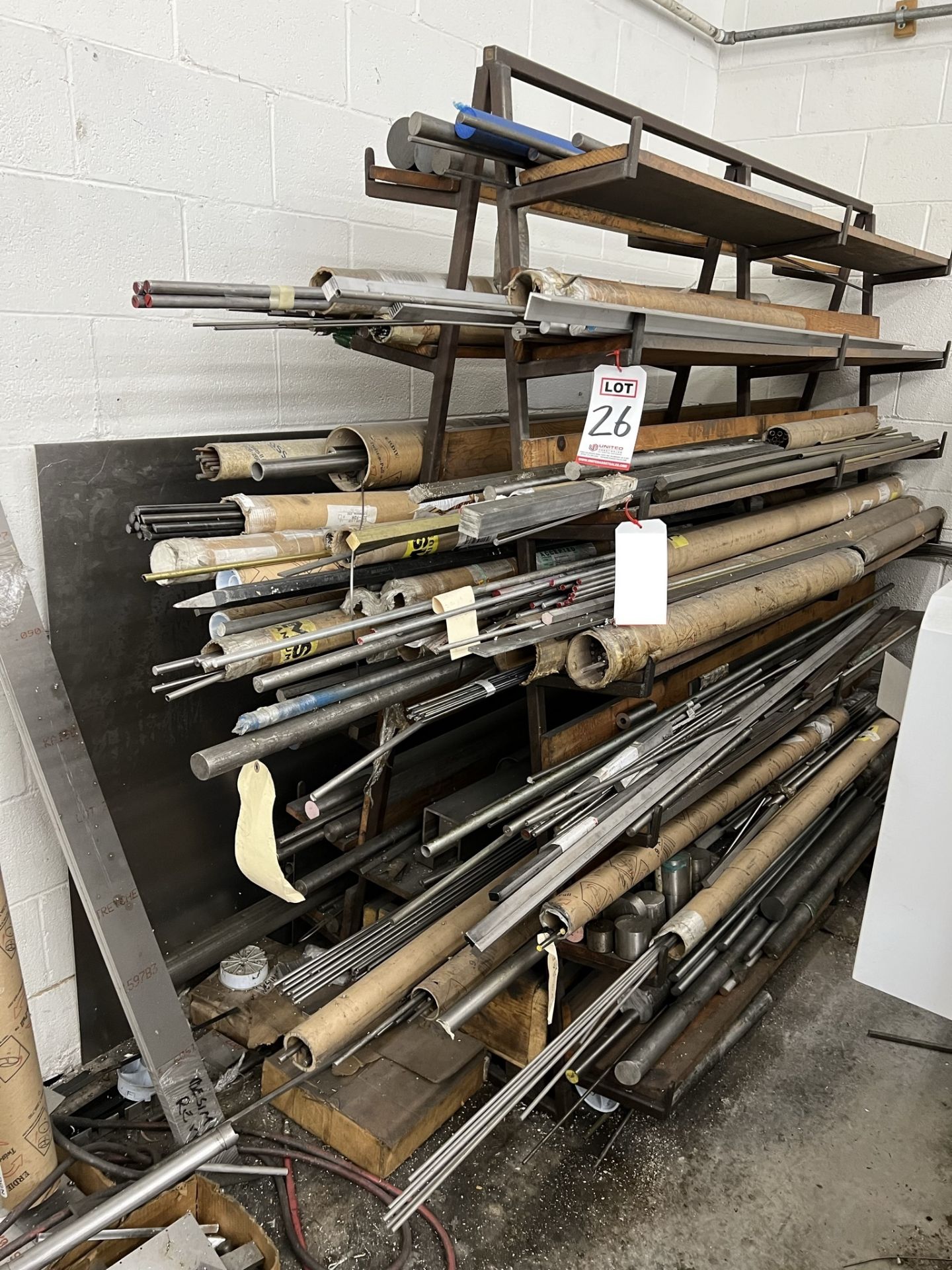LOT - MATERIAL RACK, W/ CONTENTS: STEEL, STAINLESS STEEL, ALUMINUM, TITANIUM RODS, LENGTHS UP TO 8'