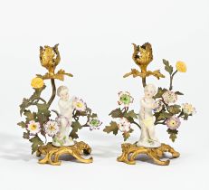 Pair of small candle holders with putti and porcelain flowers