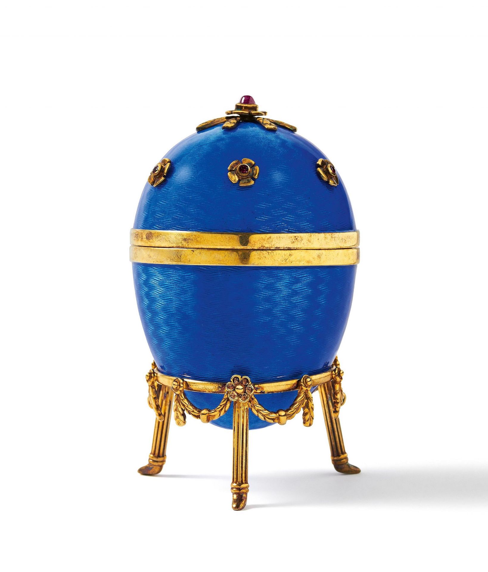 Decorative egg with violet blue enamel decor and set with gemstones