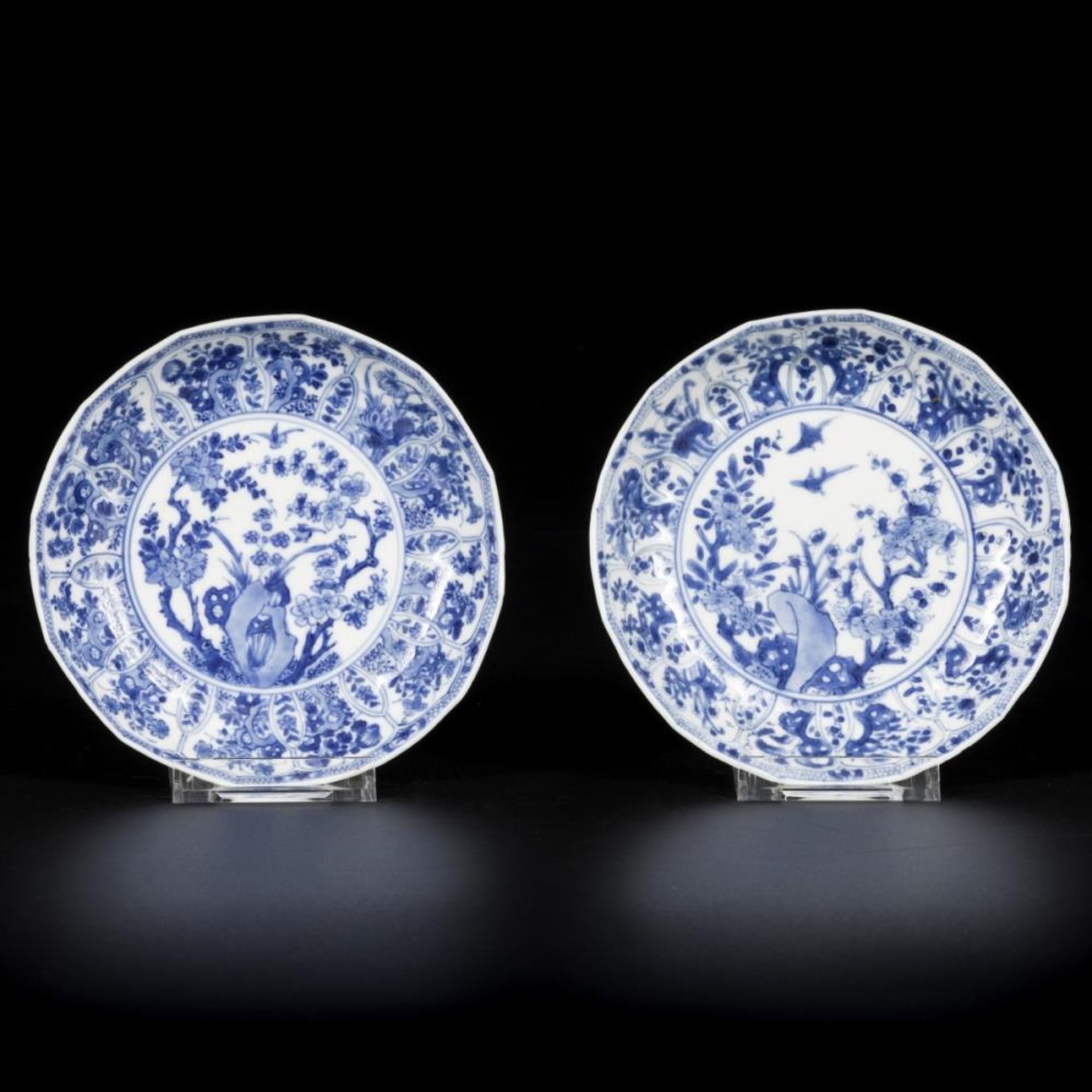 A set of (2) porcelain angled plates with rock, birds and prunus decor, China, Kangxi.