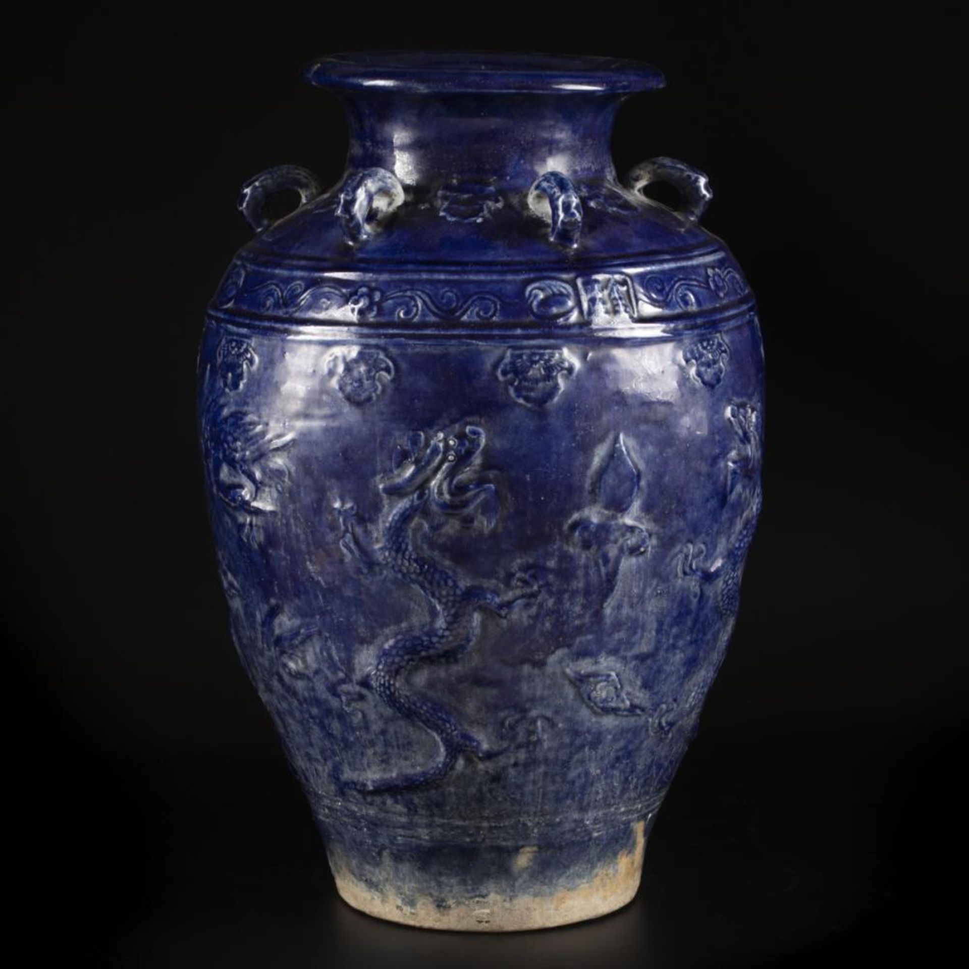 An earthenware blue glazed storage jar with dragon decoration, China, 19/20th century. - Image 2 of 18