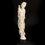 An ivory-sculpted Guan-Yin on a wooden base. China, circa 1920.