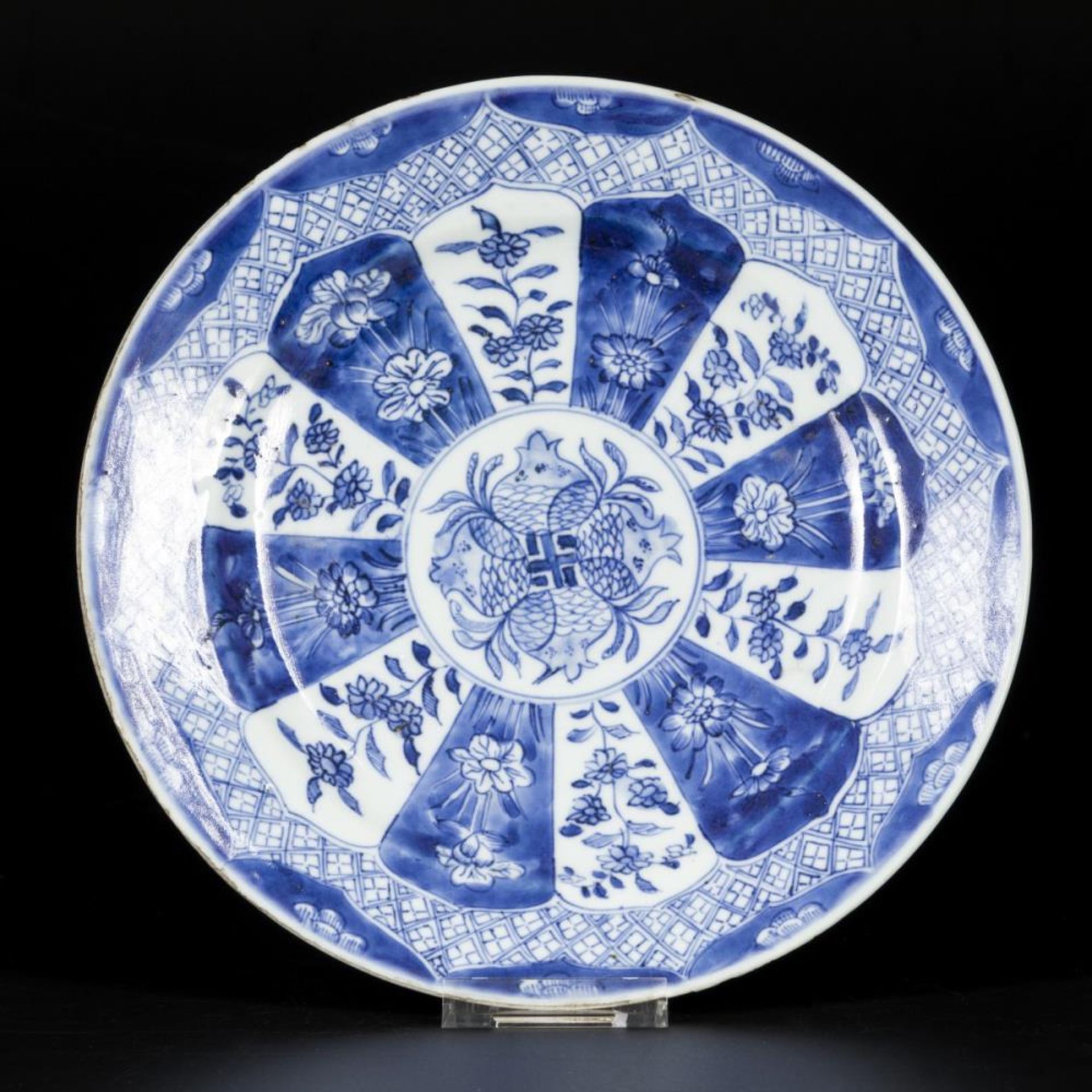 A porcelain plate with lotus leaf decor, pomegranate decor in the center, China, 18th century.
