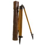 A wooden tripod, in leather carrying case.