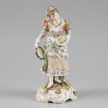 A porcelain sculpture of a lady holding a bouquet and a tambourine, marked. Richard Eckert & Co. Vol