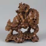 A wooden sculpture of a boy riding an ox, China, 2nd half 20th century.