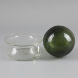 A transparent glass po together with a green glass sphere, 20th century.