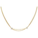 18K. Yellow gold Damiani necklace and two white gold rings set with approx. 0.13 ct. diamond.