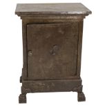An antique steel and cement safe with single door on claw feet.