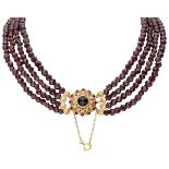Vintage four-row garnet necklace with a 14K. yellow gold closure.