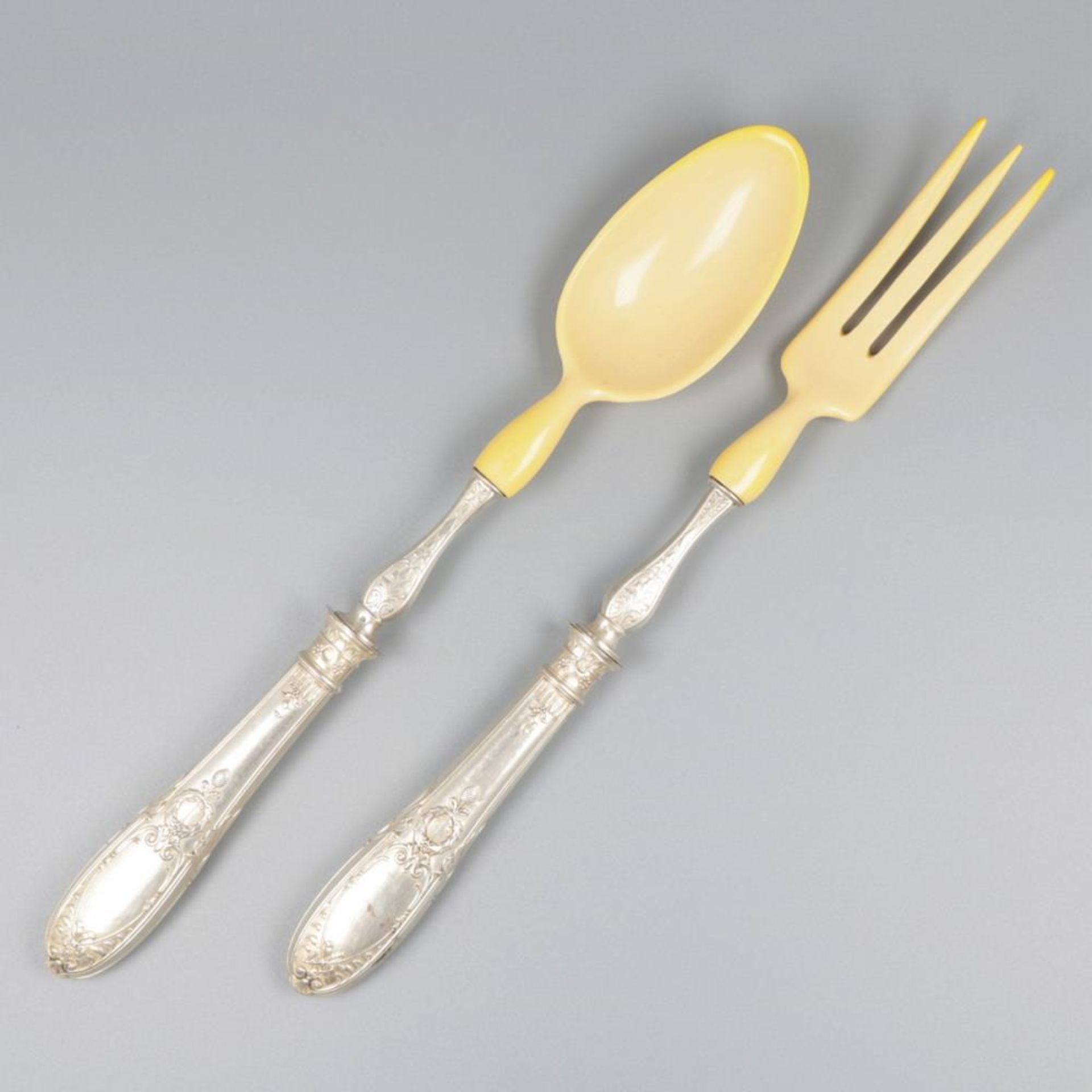 Salad servers set silver.