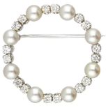 Circular 14K. white gold brooch set with approx. 0.48 ct. diamond and cultured pearl.