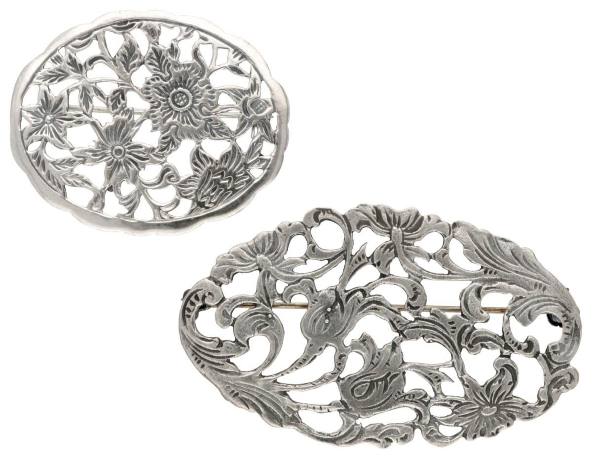 Lot of two sterling silver vintage brooches with floral details.