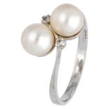 18K. White gold toi et moi ring set with diamonds and pearl.