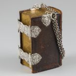 Bible with double locks and silver carrying chain.