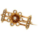 Antique 14K. yellow gold brooch with a flower set with seed pearls.