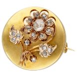 Antique 14K. yellow gold brooch with a flower set with diamond.