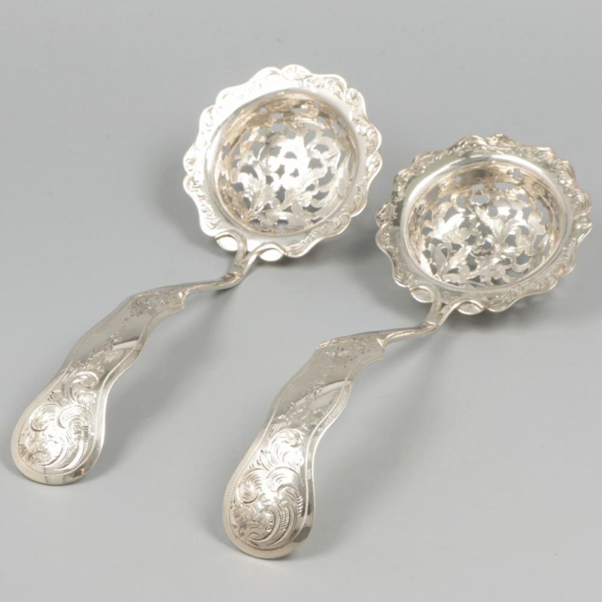 2-piece set of silver sifter spoons.