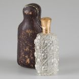 Perfume bottle with gold cap.