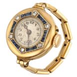 18K. Yellow gold finger watch set with diamond and synthetic sapphire.