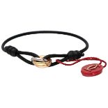 Cartier 18K. tricolor gold 'Trinity' bracelet with a black cord.