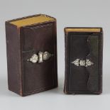 2-piece lot of bibles with silver envelope closure.