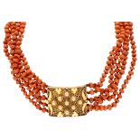 Antique five-row red coral necklace with a 14K. yellow gold filigree closure.