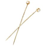 Set of two 14K. yellow gold lapel pins set with approx. 0.10 ct. diamond.