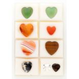 Lot of 9 various heart-shaped cut natural gemstones including agate, amber and tiger's eye.