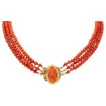 Three-row red coral necklace with a 14K. yellow gold closure set with a red coral cameo.