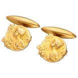 18K. Yellow gold Art Nouveau cufflinks with a lady surrounded by iris flowers, signed E. Dropsy.