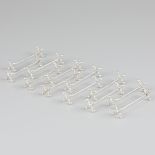 12-piece set of silver knife rests.