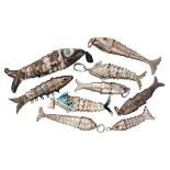 Lot of 9 silver flexible fish pendants, including two perfume pendants.