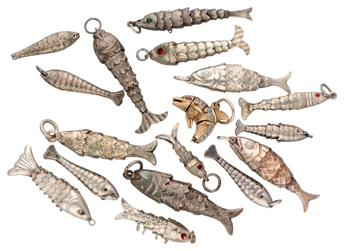 Lot of 18 silver flexible fish pendants.
