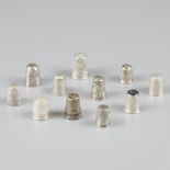 11-piece lot silver thimbles.