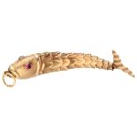 Vintage 14K. yellow gold flexible fish pendant with synthetic rubies for eyes.