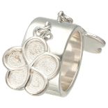 Sterling silver Christofle band ring with two flower-shaped charms.