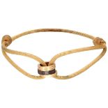 Cartier 'Love Cord' bracelet of beige silk cord with three rings and diamond.