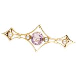 14K. Yellow gold brooch set with seed pearls and a purple gemstone.