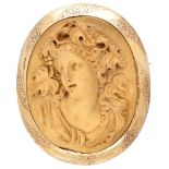 Antique lava cameo brooch in a 14K. yellow gold floral engraved frame.