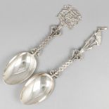 2-piece lot silver commemorative spoons.