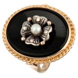 Vintage 14K. yellow gold ring set with a pearl in silver on a black plaque.