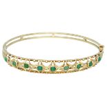 14K. Yellow gold bangle bracelet set with green colored stones.