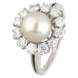 18K. White gold entourage ring set with approx. 0.96 ct. diamond and a pearl.