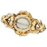 Presumably Victorian 9K. yellow gold repoussé brooch with an engraved rock crystal.
