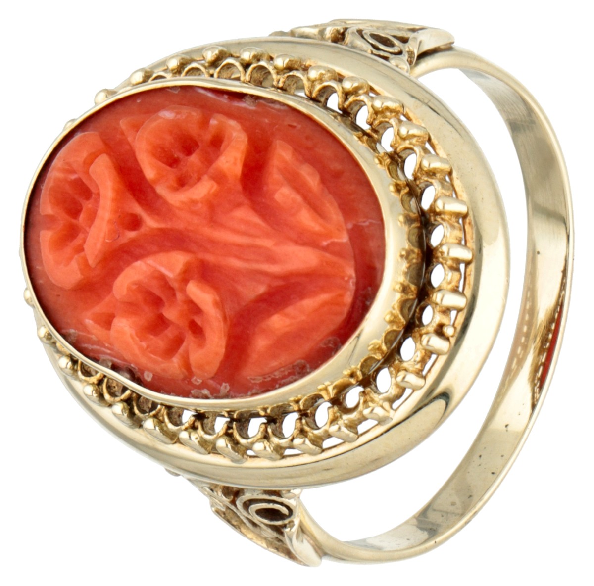 Vintage 14K. yellow gold ring set with red coral with carved floral representations.