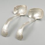 2-piece set of silver scoop-spoons.
